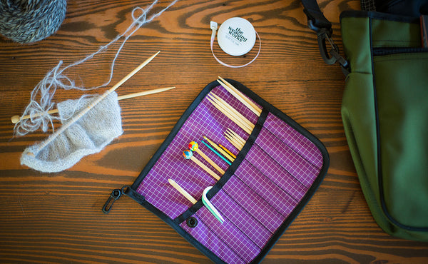 A Pen Tool Wrap filled with knitting tools.